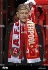 a-cardboard-cut-out-of-arsenal-manager-Arsène-wenger-wearing-a-half-and-half-scarf-before-the-...jpg
